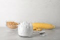 Jar and spoon with corn starch on table Royalty Free Stock Photo