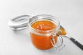 Jar and spoon with sweet jam Royalty Free Stock Photo