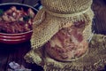 A jar of stewed meat and a frying pan on a wooden countertop. Royalty Free Stock Photo