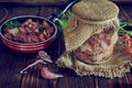 A jar of stewed meat and a frying pan on a wooden countertop. Royalty Free Stock Photo