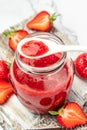 Jar of strawberry jam and fresh berries on white background. Homemade strawberry marmelade and fruit