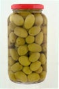 A jar of stuffed green olives isolated Royalty Free Stock Photo