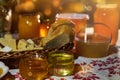 a jar of sweet honey on a table from a garden with apples in a bowl drips from a brush from a spoon a glass jar with