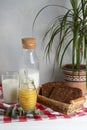 Jar with tasty honey, milk and bread on white wooden table Royalty Free Stock Photo