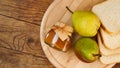 Jar of tasty pear jam with bread and fresh pear fruit on wooden table. Top view Royalty Free Stock Photo