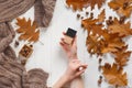 Jar with a tonal cream in the hands of a girl. Top view. Natural beauty cosmetics concept. Autumn beauty