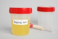 Jar with urine sample on light grey background, space for text. Doping control Royalty Free Stock Photo