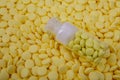 Jar of yellow pills lies on other medicines. Drugs, painkillers, colds macro
