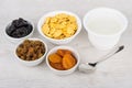 Jar of yogurt, dried fruits, corn flakes in bowls Royalty Free Stock Photo