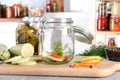 Jar with zucchini dill on grey marble table indoors. Pickling vegetables