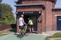 Cyclists waiting to enter lift to cycle tunnel outside on summers day