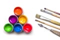 Jars with colorful art paint and brushes are on a white background Royalty Free Stock Photo