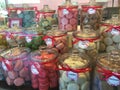 Jars of colorful macaroon cakes on display in store front