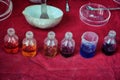 Jars with colorful reagent in an old chemical laboratory. Chemicals in bottles with colored liquids. Table with tools and dies for Royalty Free Stock Photo