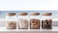 Jars containing beach pebbles and sand on window sill with beach view. Concept of summer holiday Royalty Free Stock Photo