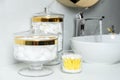 Jars with cotton balls, swabs and pads on countertop in bathroom Royalty Free Stock Photo
