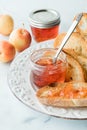 Jars of crab apple jelly with some on a slice of toasted sourdough bread Royalty Free Stock Photo