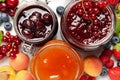 Jars with different jams and fresh fruits on white wooden table, flat lay Royalty Free Stock Photo