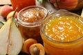 Jars with different jams and fresh fruits on table, closeup Royalty Free Stock Photo