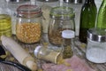 Jars with different spices and a kitchen roller on a round wooden table