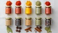 Jars filled with assorted spices are organized in two rows on a Royalty Free Stock Photo