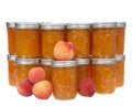 Freshly canned jars of peach jam with fruit on and around jars isolated Royalty Free Stock Photo