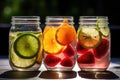 Jars of fruit-infused water. Slices of fresh fruits float elegantly. Royalty Free Stock Photo