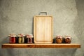 Wooden tray with some jars on wooden shelf. Copy empty space for your decoration and products. Beige brown retro wall background. Royalty Free Stock Photo