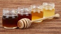 Jars full of honey wooden drizzler Royalty Free Stock Photo
