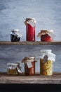 jars of homemade canned blueberry and rose jams, orange marmalade, eggplants and zucchinies