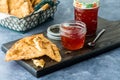 Jars of hot red pepper jelly served with crispy tortilla crackers for dipping. Royalty Free Stock Photo