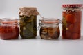 Jars of Homemade pickled vegetables: cucumbers, tomatoes, honey agarics mushrooms, on white  background. Royalty Free Stock Photo