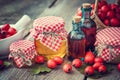 Jars of honey, tincture bottles and mortar of hawthorn berries