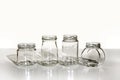 Jars isolated white background glass shadow table gray glassware set empty four clear transparent black Royalty Free Stock Photo