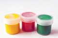 Jars with multi-colored gouache or acrylic paints on a light white background. Selective soft fokus. Text copy space Royalty Free Stock Photo