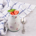 Jars of natural white yogurt decorated with fresh strawberry and mint. Healthy eating Royalty Free Stock Photo