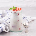 Jars of natural white yogurt decorated with fresh strawberry and mint. Healthy eating Royalty Free Stock Photo