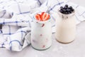 Jars of natural white yogurt decorated with fresh strawberry and mint. Healthy eating Royalty Free Stock Photo