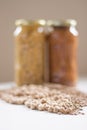 Jars of non-perishable chickpeas and lentils with spilled seeds on the table purchased