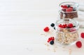 Jars of oat flakes and fresh berries