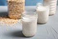 Jars with oat milk and flakes