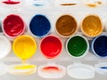 Jars with paints of different colors, top view, close-up, development of artistic skills in children, drawing, hobbies, drawing