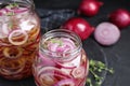 Jars of pickled onions on grey table Royalty Free Stock Photo