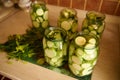 Jars with pickled slices of ripe organic zucchini, marinated in brine, with fresh dill, garlic cloves. Canning Food