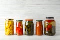 Jars with pickled vegetables on white table Royalty Free Stock Photo