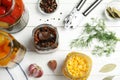 Jars with pickled vegetables on white wooden table Royalty Free Stock Photo