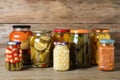 Jars with pickled vegetables on wooden table Royalty Free Stock Photo
