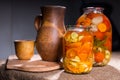 Jars of Pickles on Table with Wooden Handicrafts