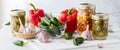 Jars of preserved peppers with fresh peppers beside. Royalty Free Stock Photo