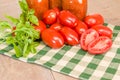 Jars of sauce with paste tomatoes and basil Royalty Free Stock Photo